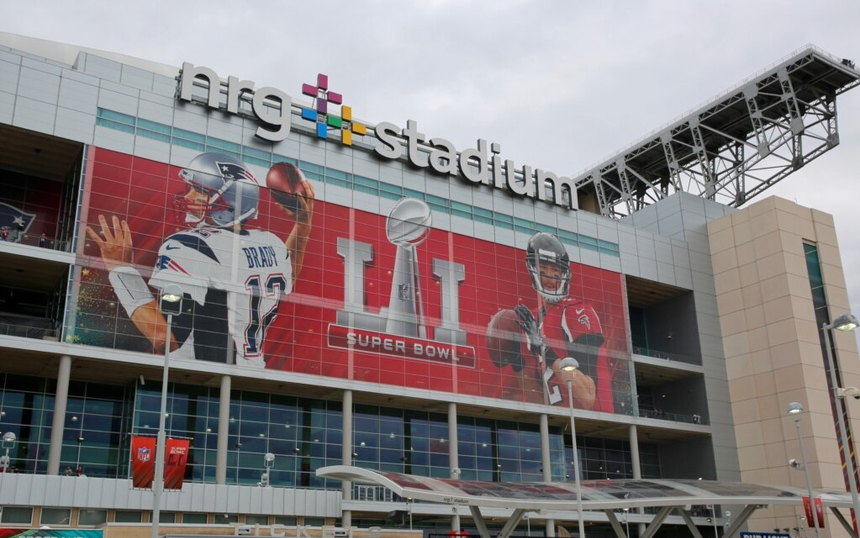 The exterior of NRG Stadium wrapped in Super Bowl signage