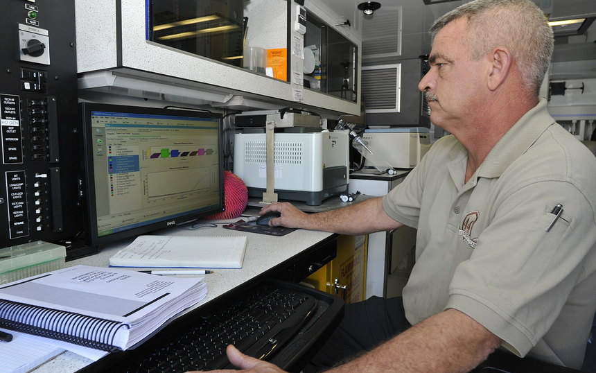 A technician at a console inside a mobile command vehicle