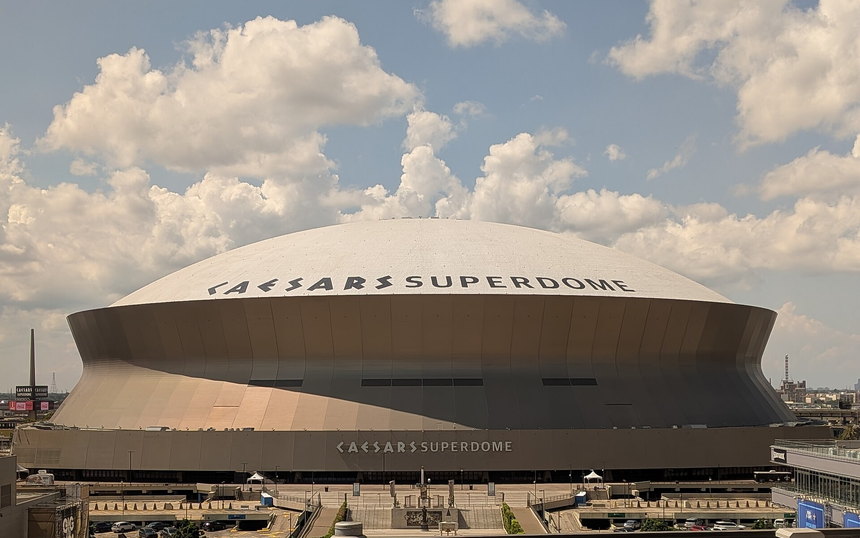 The Caesars Superdome under cloud, its name across the roofline